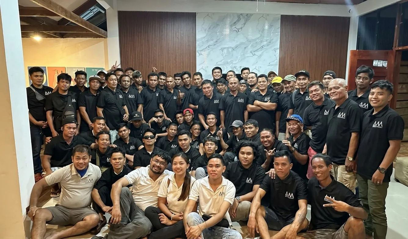 The whole A.M Architects+ team, architects, engineers and builders, gathered together in matching black polos